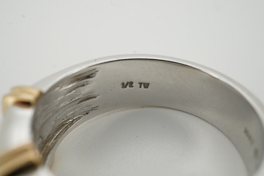 A modern two colour 10kt and two row channel set diamond dress ring, size U/V, gross weight 11.2 grams. Condition - fair to good